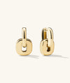 Stevie Hoops gold earrings with interchangeable, reversible links for customizable looks. Close-up details of the chain and metalwork emphasize design versatility.