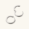 Tube Medium Hoops: A pair of silver hoop earrings with a modern tube design and clicker closure for comfort and security.