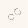 Pavé Diamond Small Hoops: A pair of silver hoop earrings featuring pavé diamonds, handcrafted in recycled 14k solid gold, designed for versatile wear.