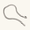 Double Curb Chain Bracelet: a close-up of a silver, double curb chain with a clasp, showcasing intricate links for a bold statement piece.