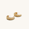 Large Croissant Dome Hoops: close-up of gold, croissant-shaped earrings, capturing intricate detailing influenced by Parisian style, enhancing an elegant, French-inspired look.