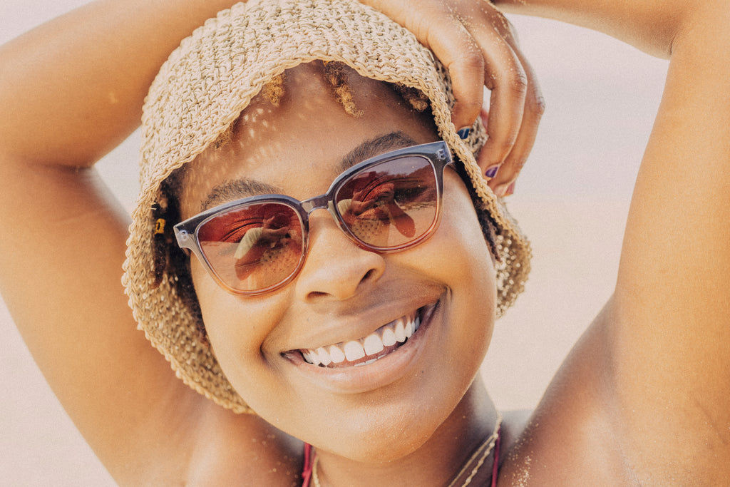 Smiles in a bucket hat and cool sunglasses