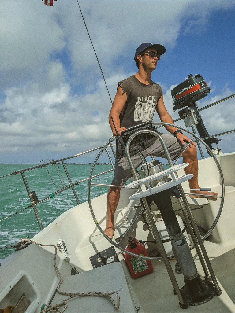 guy driving boat wearing sunski sunglasses