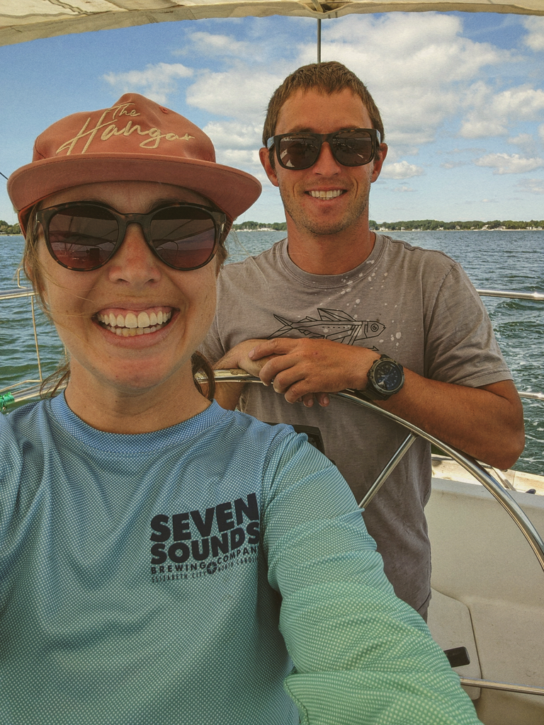 man and woman sailing wearing sunski sunglasses