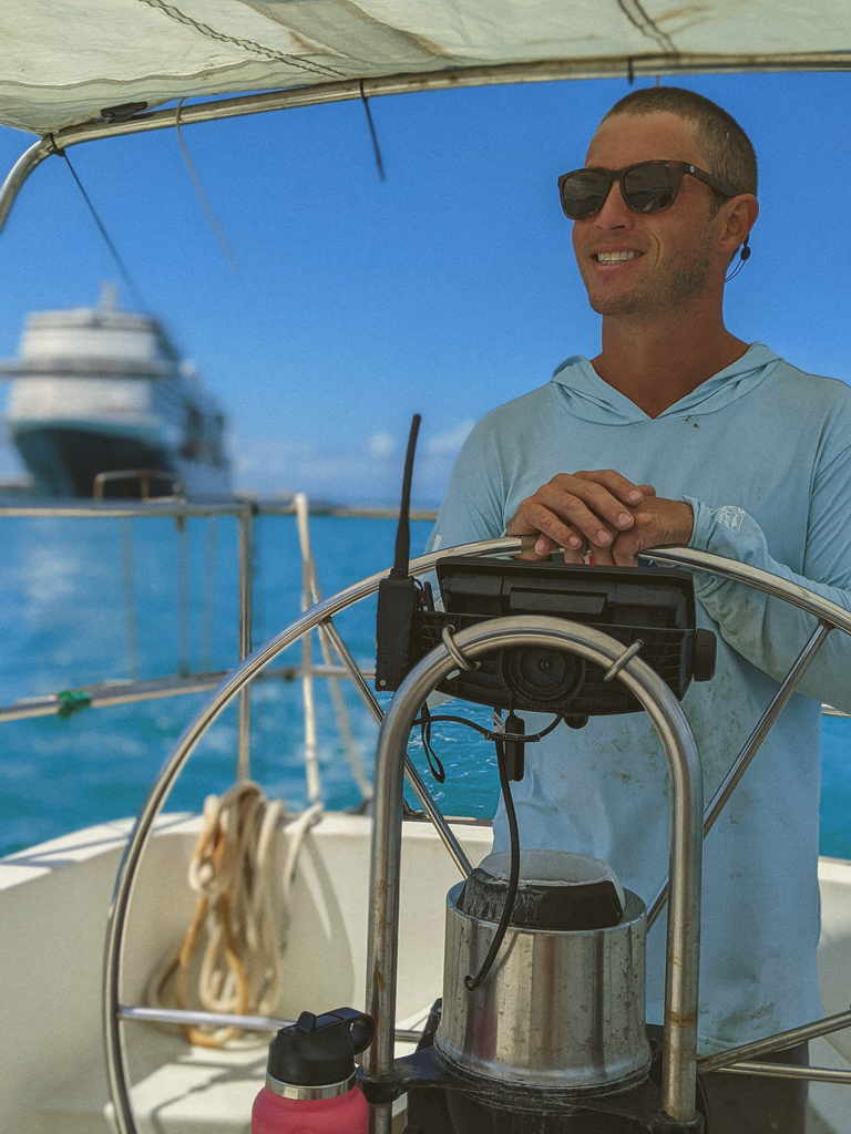 man driving a boat wearing sunski madrona sunglasses