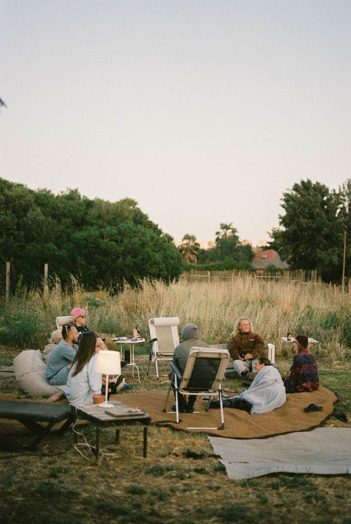 Friends sitting in circular chair formation 