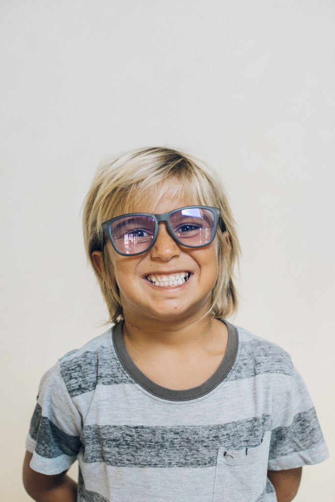 boy wearing sunski blue light blocking glasses for kids