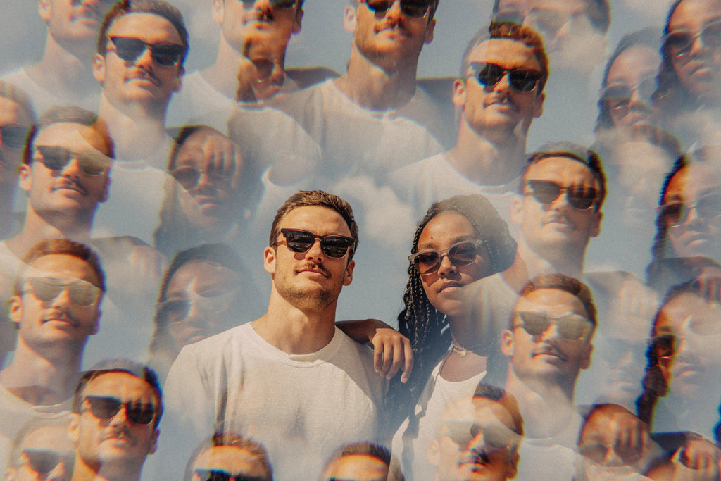 Multiple, faded images of two people in shades on a sunny day