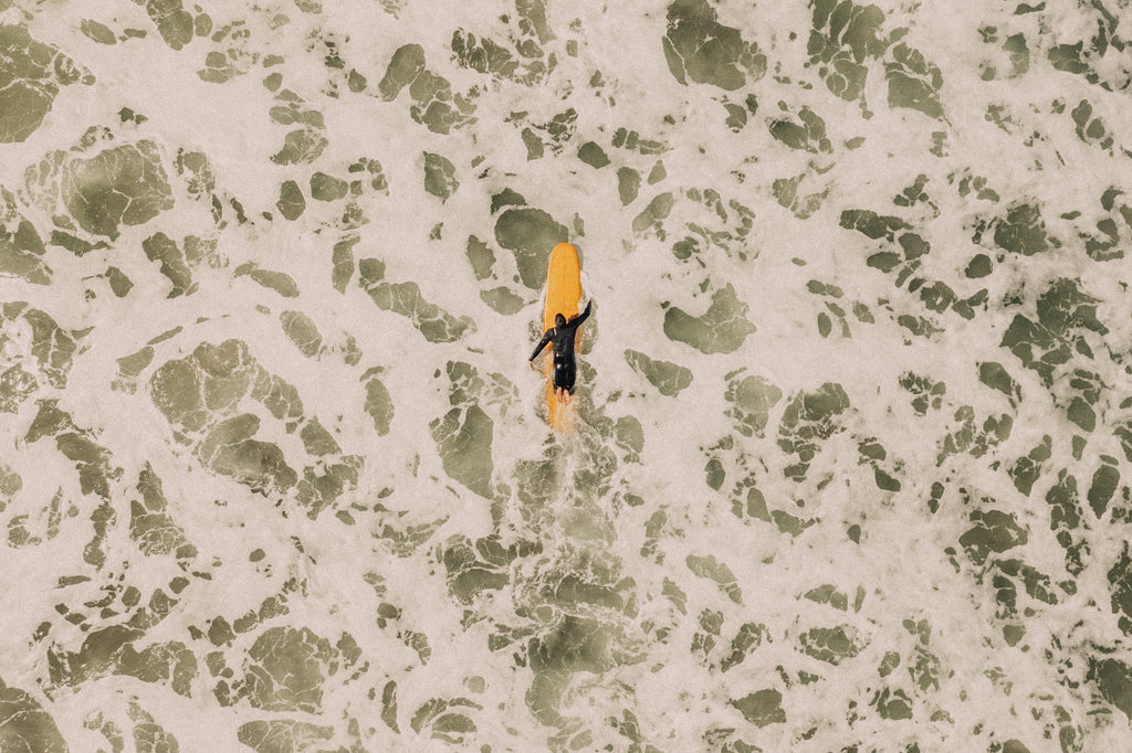 Aeriel view of a love surfer on the ocean