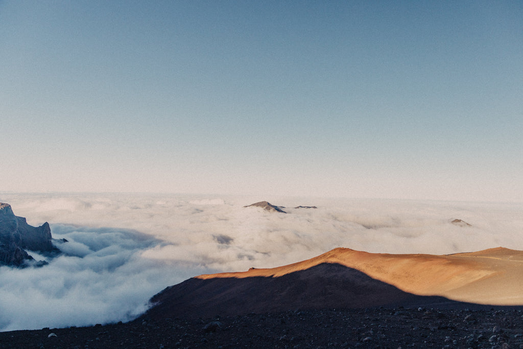 Fog and clouds drifting between the mountains on a sunny day