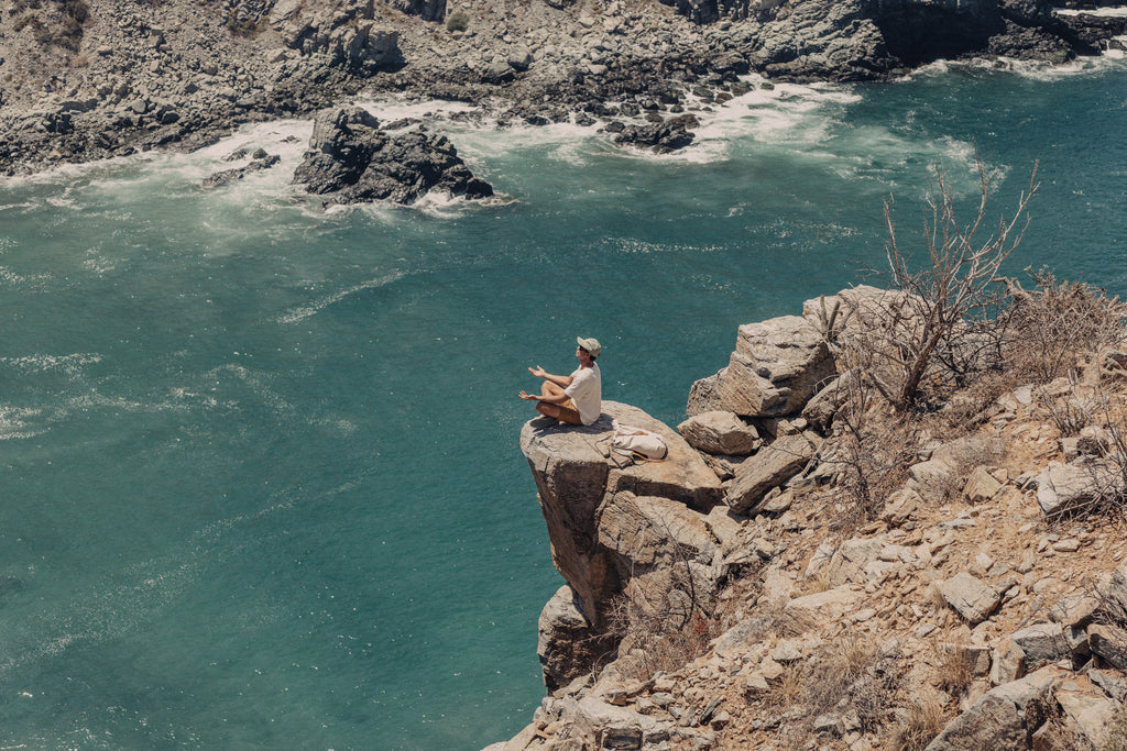 Meditating on a cliff above a cove