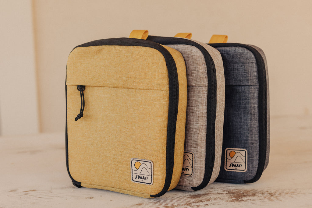 Sunski travel cases in Yellow, Sand, and Graphite