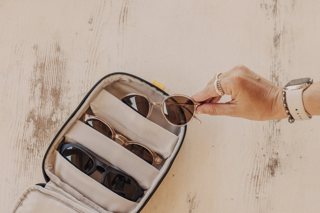 Placing a pair of sunglasses in a travel case