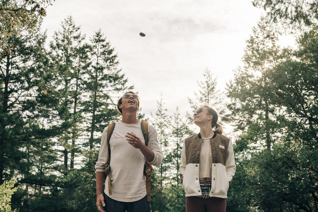 Two people joking together on a walk in the forest