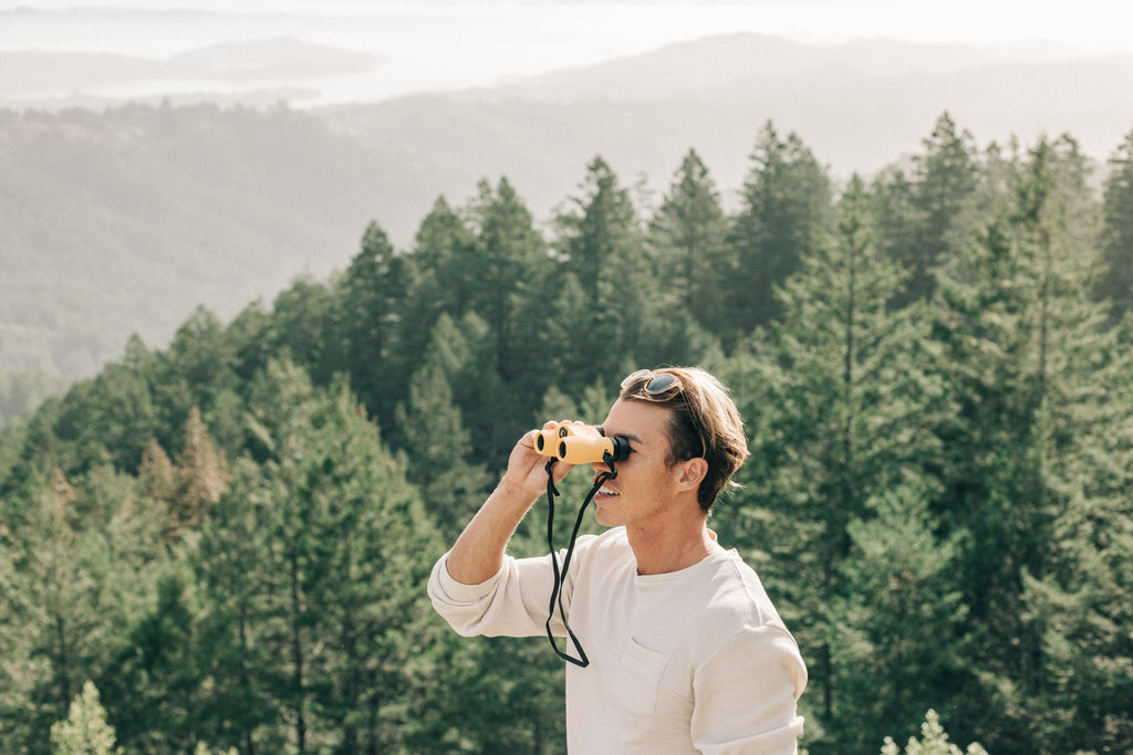 Checking out the forest view through binoculars