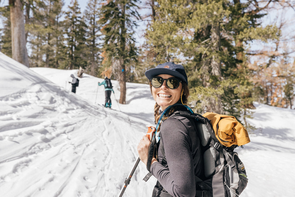 Woman out enjoying snow sports with a wide smile