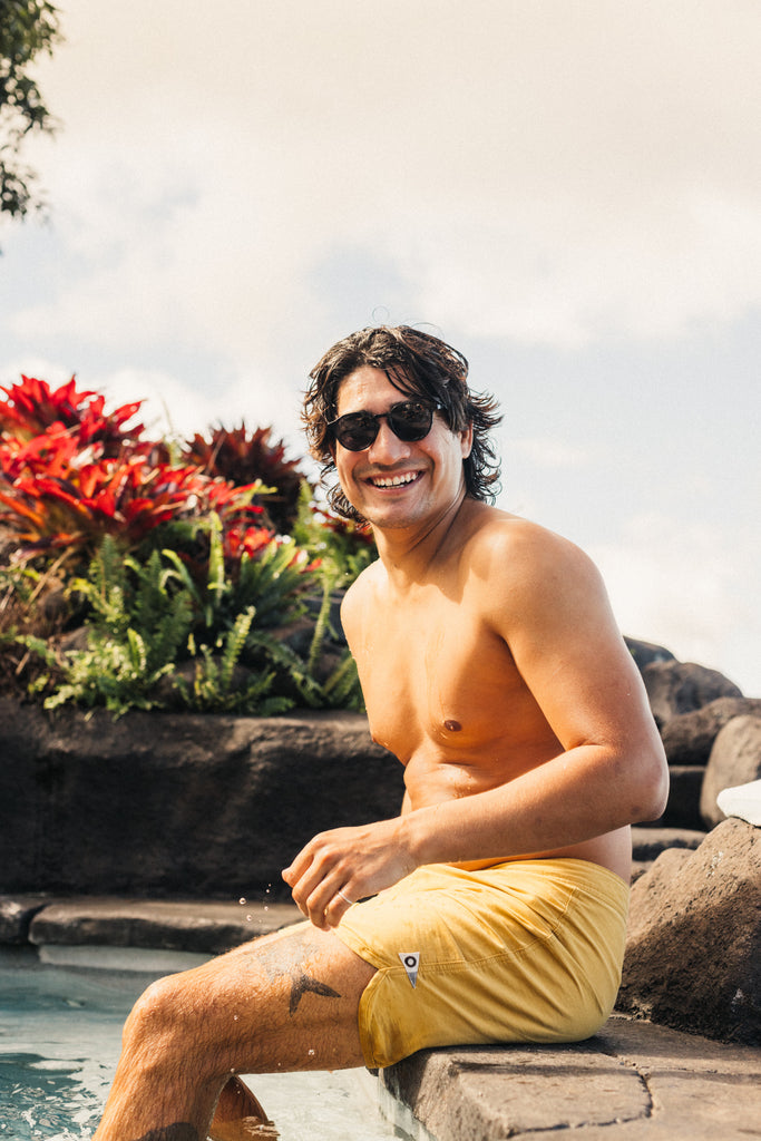 guy laughing sitting on edge of pool