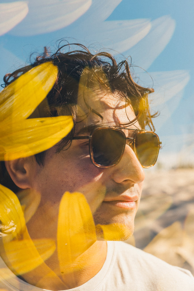 flowers overlaying man wearing sunski estero