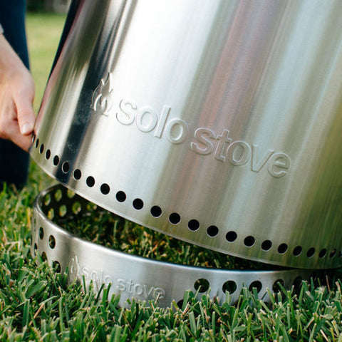 Putting a Solo Stove Stand under the fire pit on top of grass