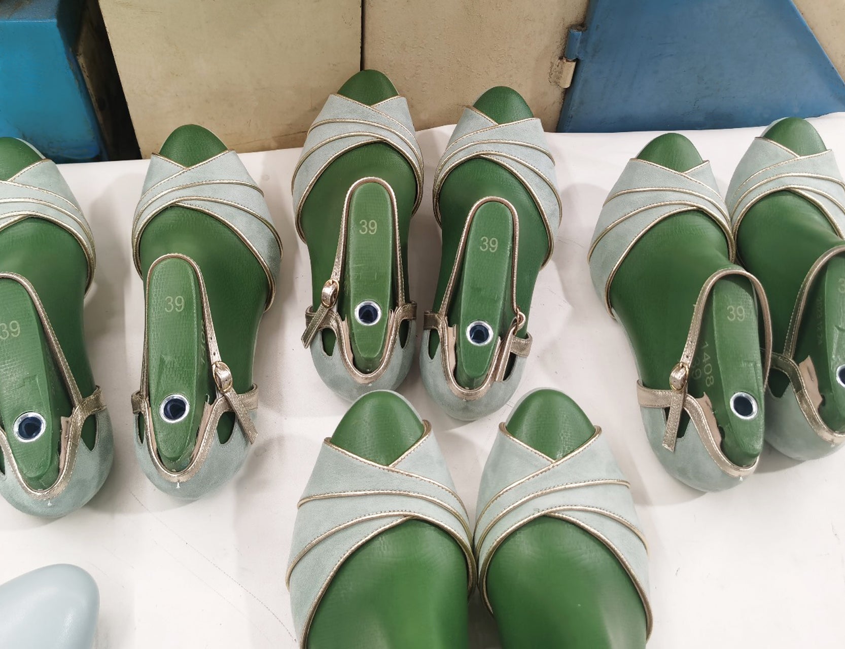 Mint green suede shoes on a production line