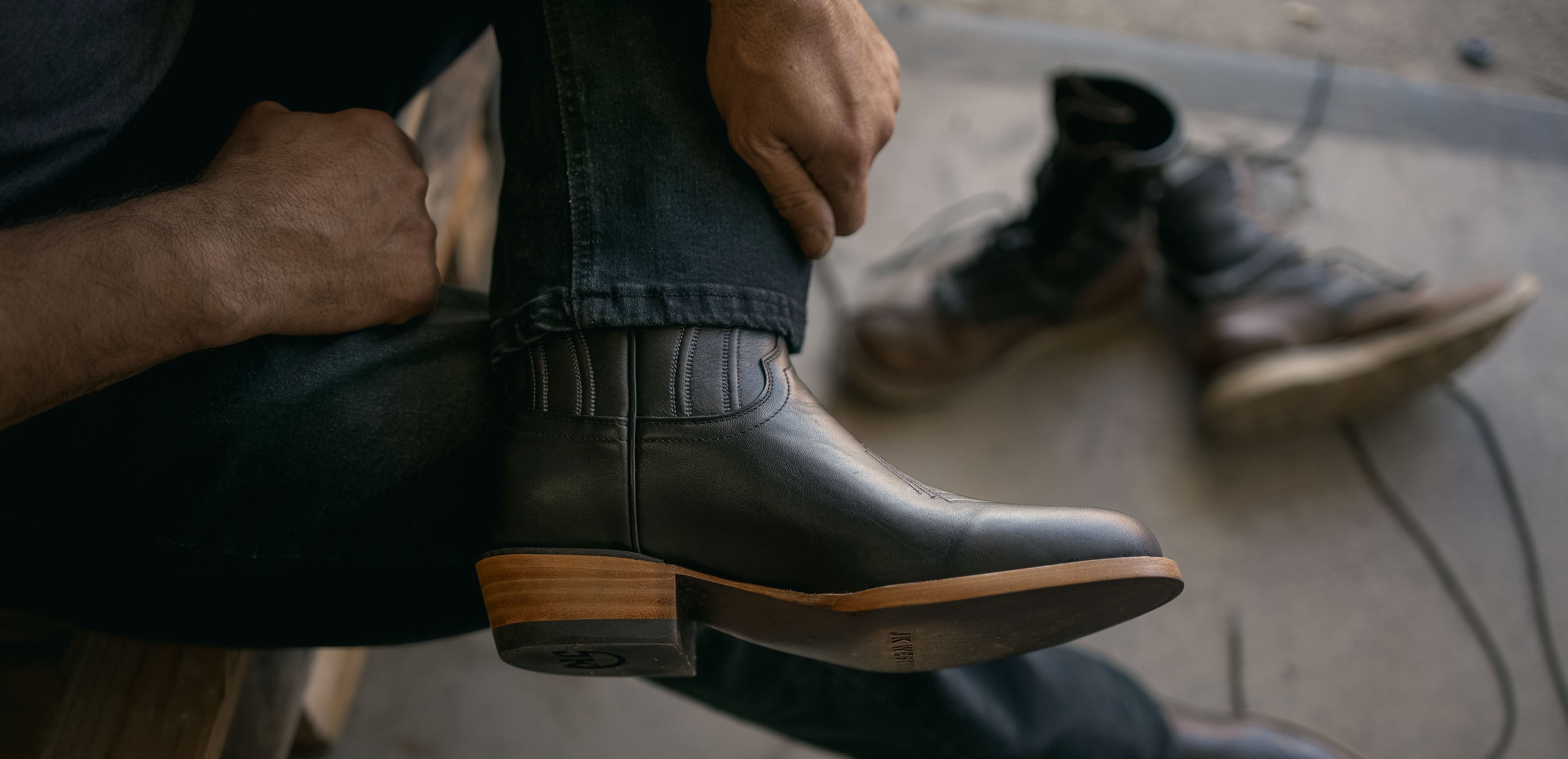 Founder wearing new cowboy boots with JK Work boots in the background