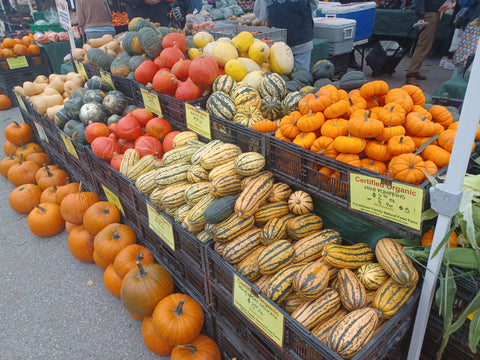 Baskets full of colorful squashes at local farmers market