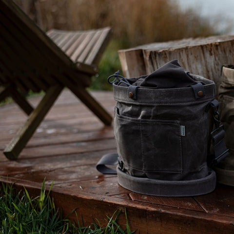 Scenic picture lakeside with a Foraging Bag from GrowOya.com and a wooden chair and wood block on a deck.