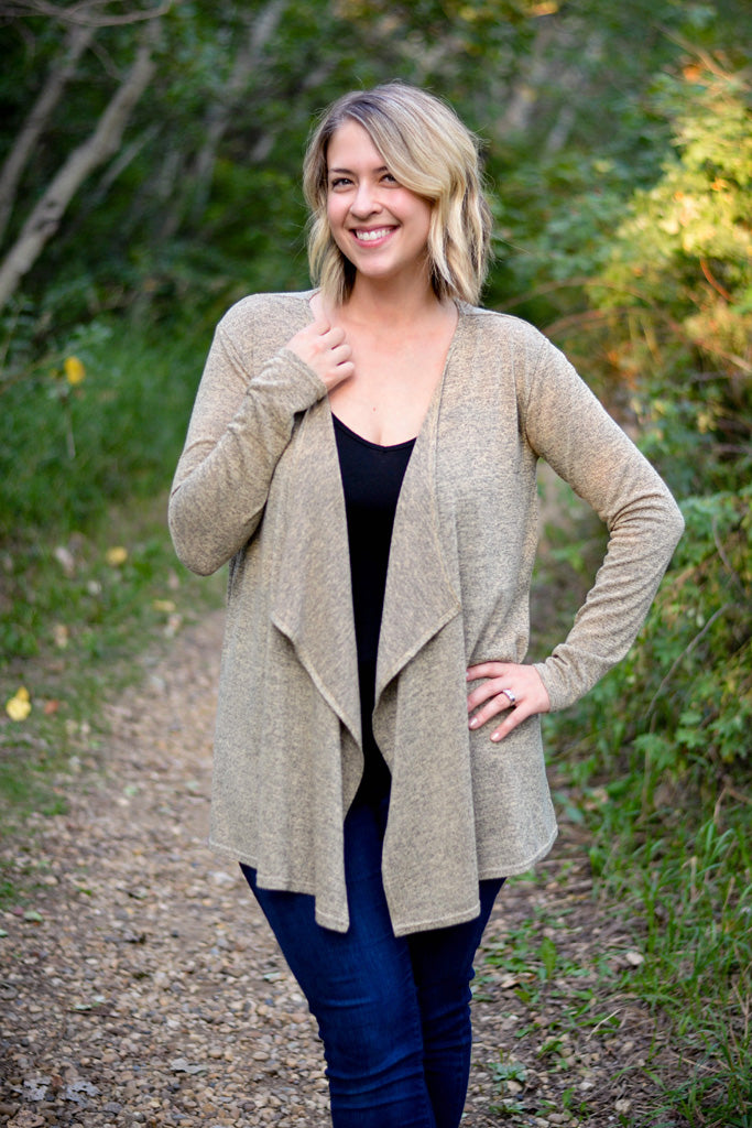 model wears a light neutral coloured waterfall style cardigan
