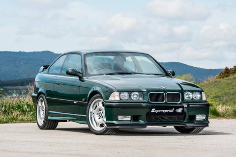BMW E36 M3 GT in British Racing Green, highlighting its classic racing-inspired design, bold green paint, and sporty accents. The image captures the car's exclusive look and heritage.