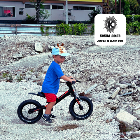 Young boy riding his KOKUA Bikes Jumper 12 Black Dirt