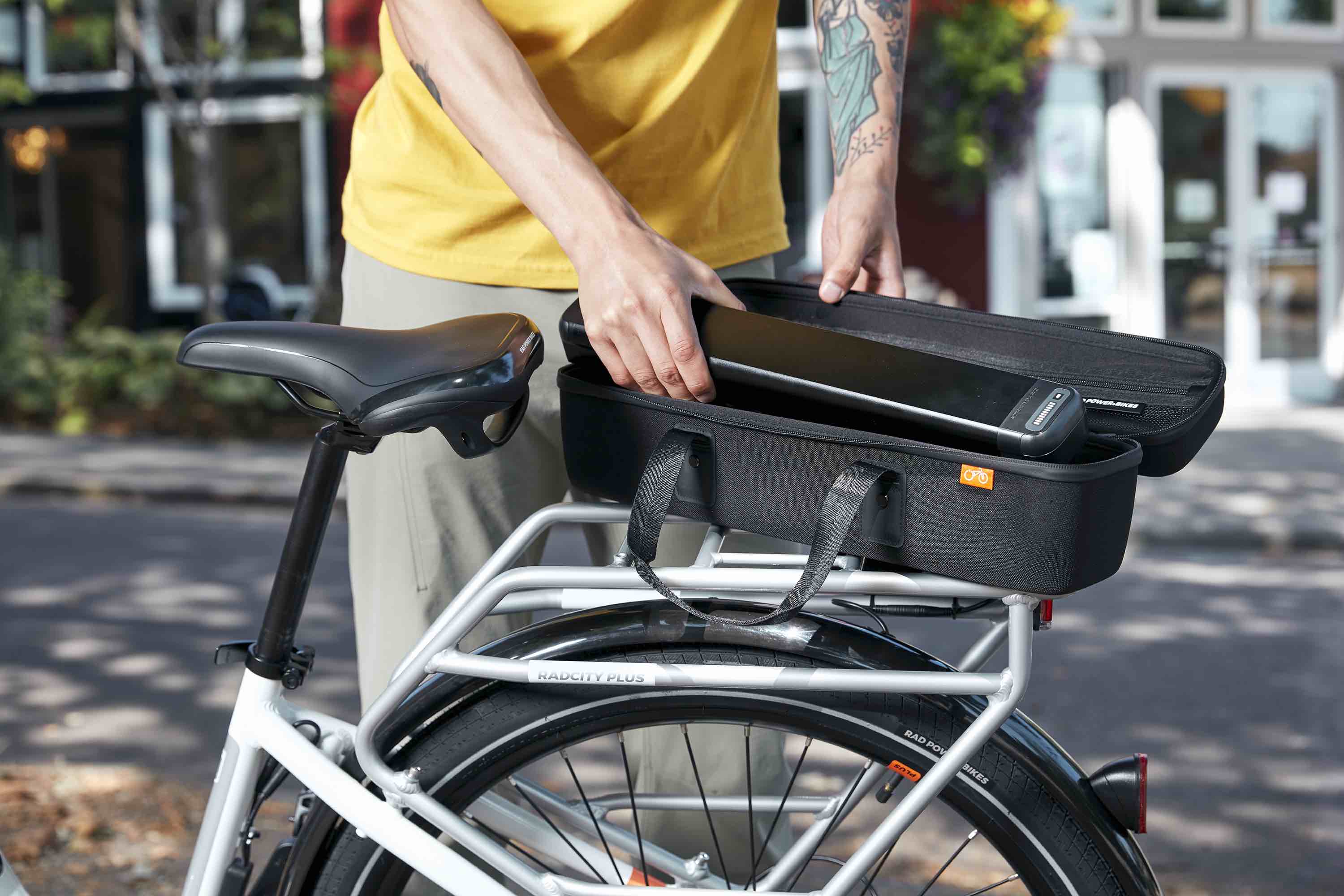 A man removes a battery from a RadCity and places it in a carrying case.