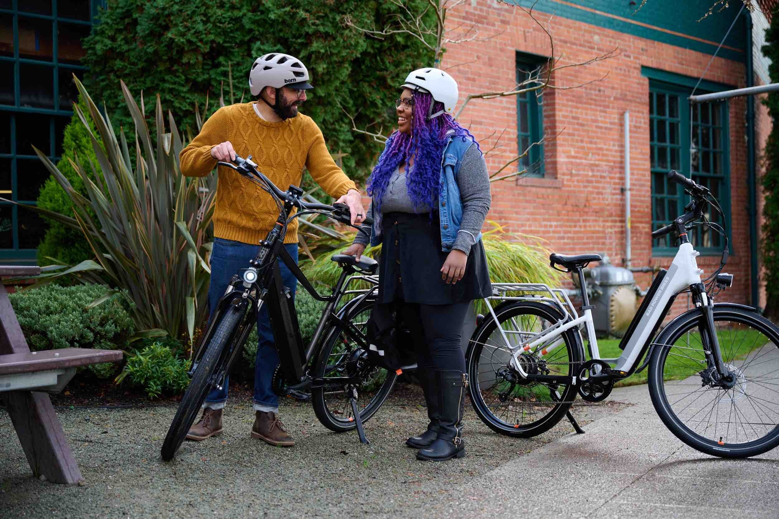 Couple stands next to RadCity ebikes.