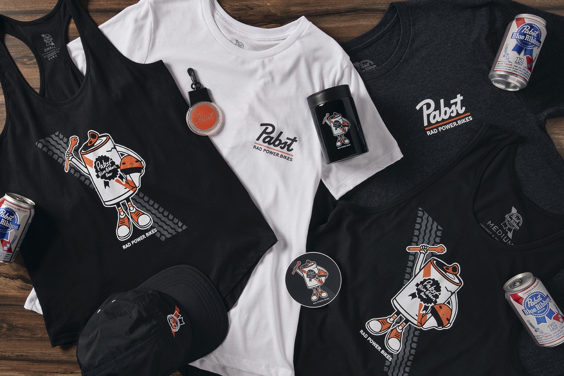 A collection of Rad Power Bikes X Pabst Blue Ribbon themed apparel and accessories.