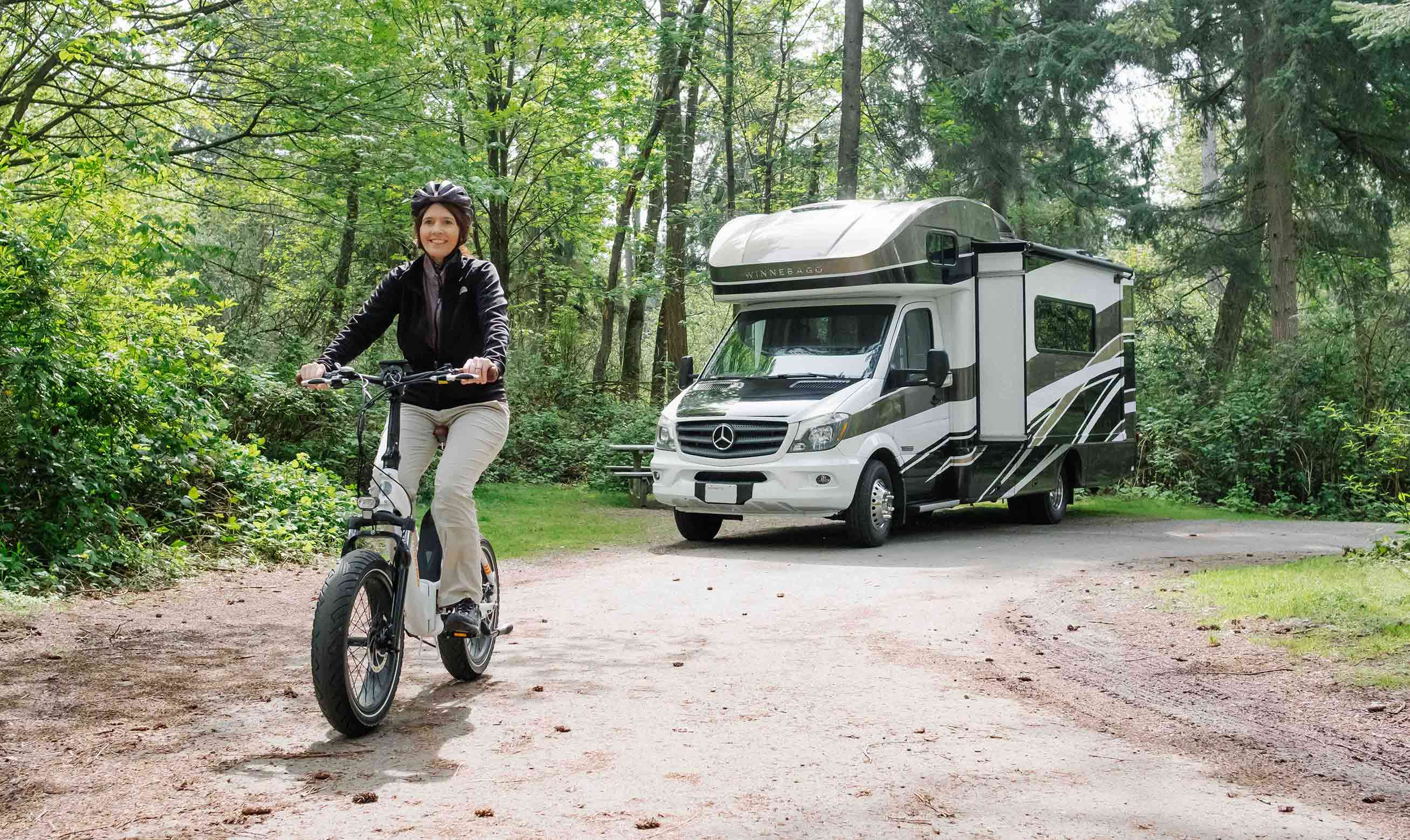 A woman rides away from her RV on a RadMini