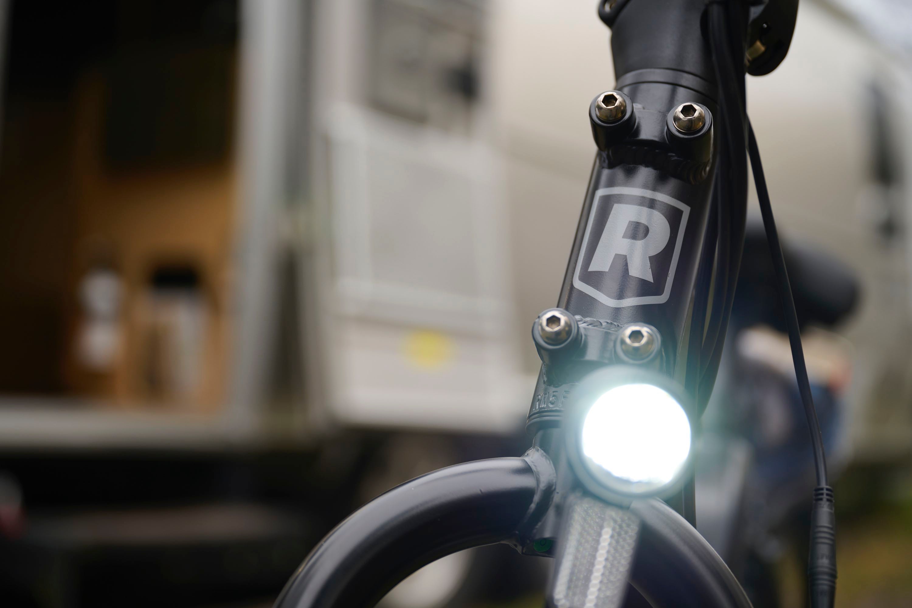 A close-up of the headlight on the RadExpand electric folding bike.