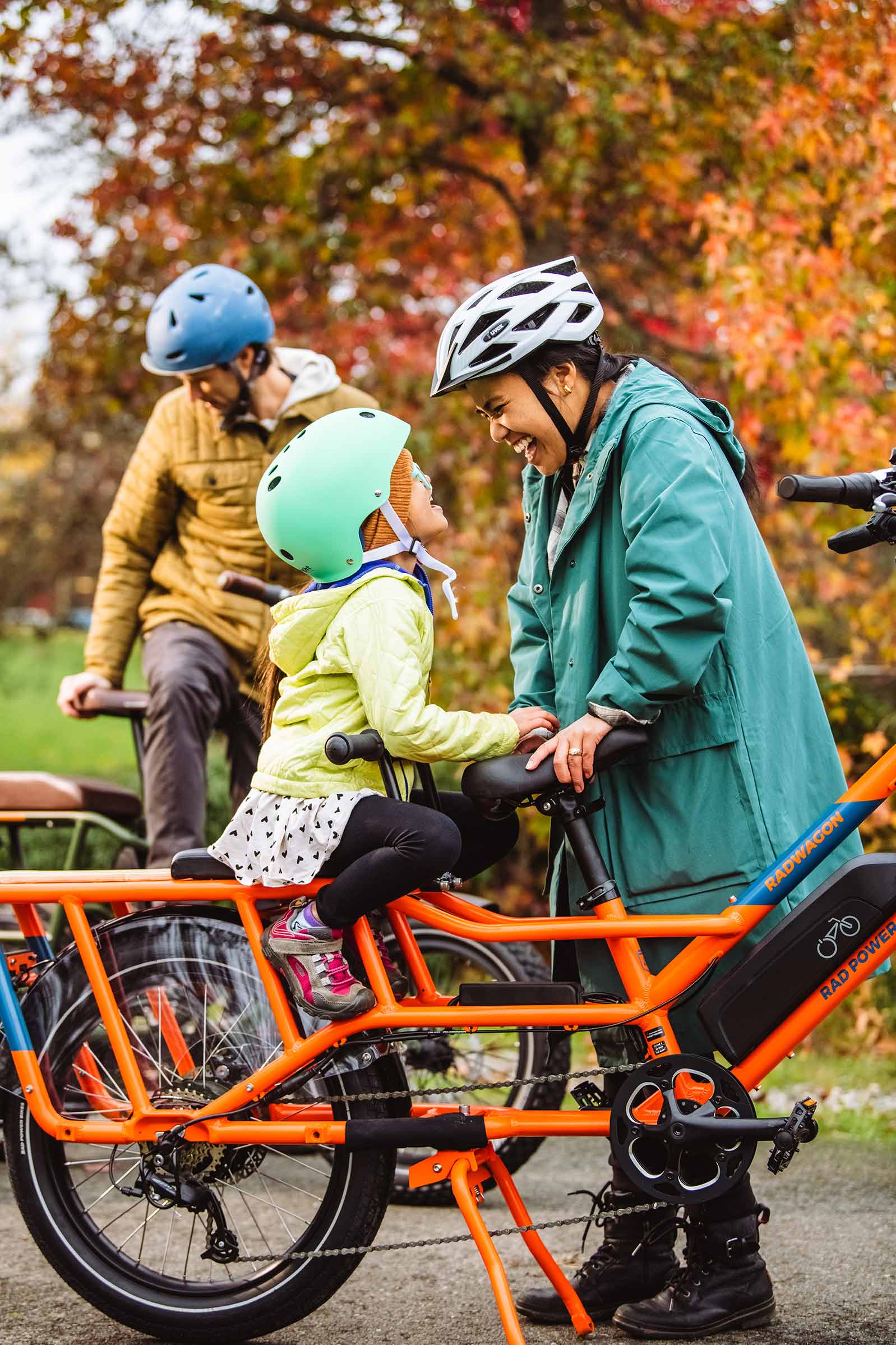 A family poses next to their electric bikes in a Seattle park.