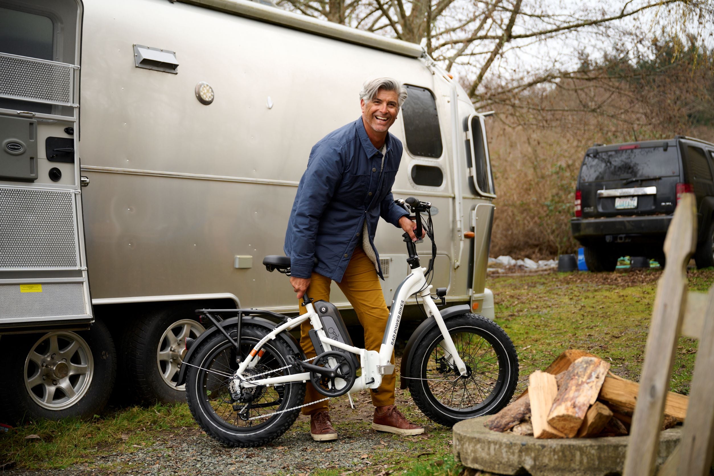 Man smiles with folding ebike.