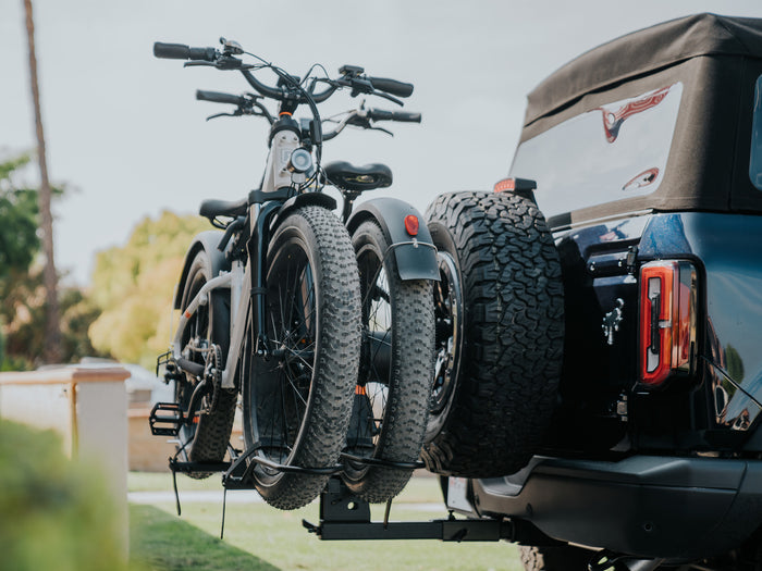 two ebikes on a car bike rack