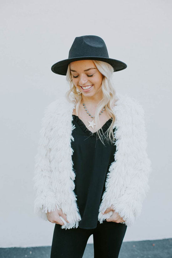 Trendy woman in white shag fur jacket