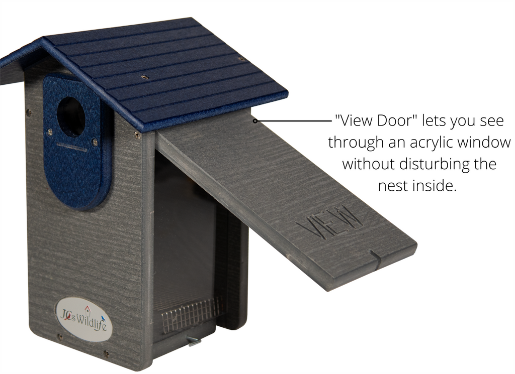 Close-up of a gray birdhouse by 'JCs Wildlife'. Features a dark blue roof and a special 'View Door' on the right side with an acrylic window. The door allows for viewing inside without disturbing the nest. The side of the birdhouse also displays a subtle 'VIEW' engraving.