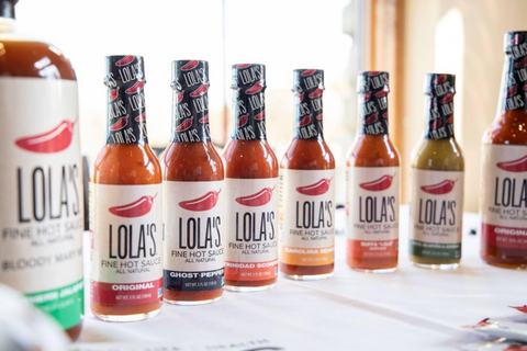 lola's hot sauce lineup on kitchen counter