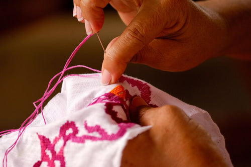 medium-Hands embroidering Pollera.jpg__PID:218319e0-f9d0-406b-bbf2-c265162c2ccc