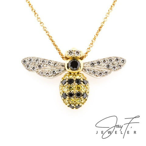 Custom made bee necklace with a bee pendant made out of black, yellow, and white diamonds.