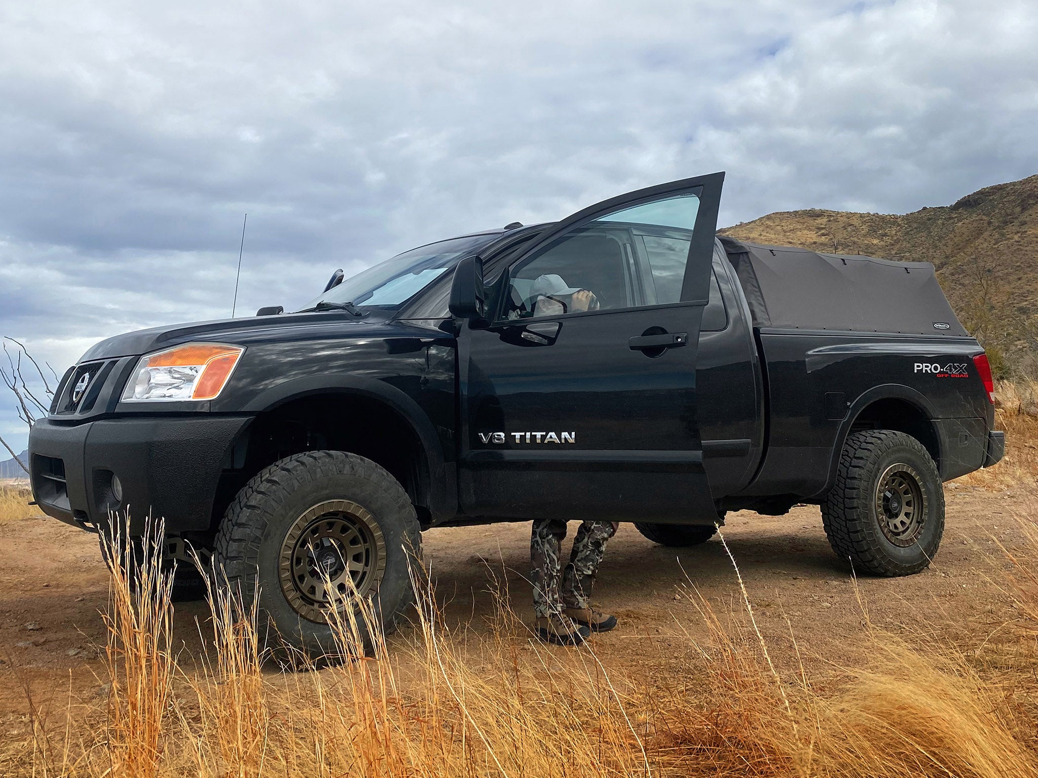 overland sector wheels rig gallery Joey's Nissan Titan Pro 4x on 17x9 satin bronze venture wheels 3 inch lift 34 inch tires custom bumper off-road lighting bed topper camping supplies roof rack and more.