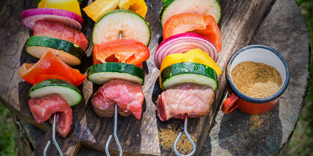 Three vegetable skewers with chunks of tri tip steak ready for the grill