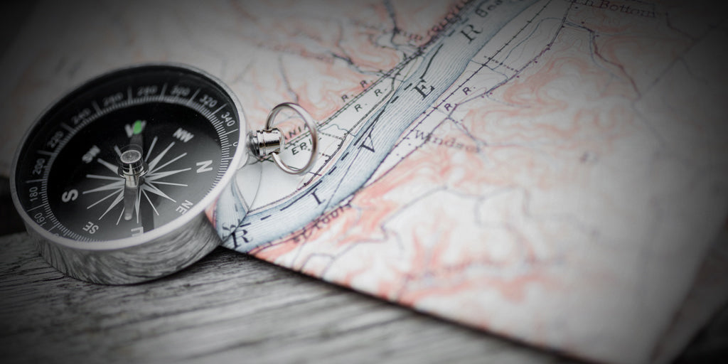 image of a compass and a topographic map