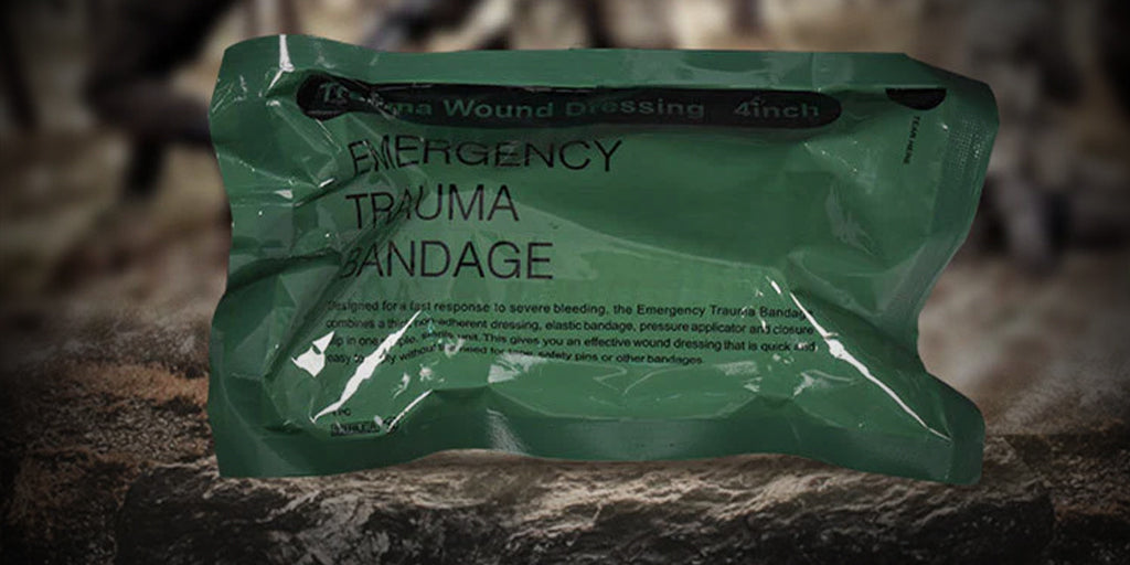image of a first-aid bandage still inclosed in a military-style army green packaging placed on top of a large rock in the forest