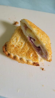A toasted snack with cheese and ham
