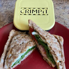 A toasted snack with ham and salad next to the CRIMPiT square
