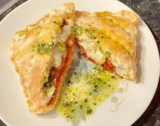 A toasted snack with pesto, mozzarella and tomato